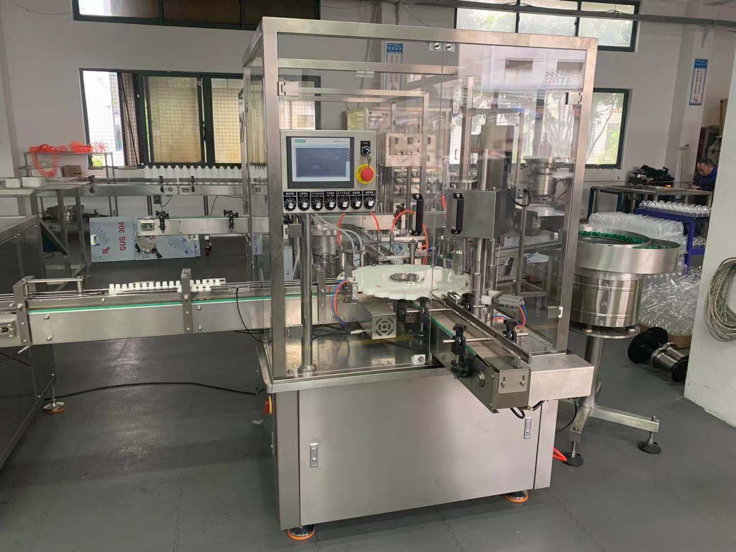 Vials filling and stoppering machine 10