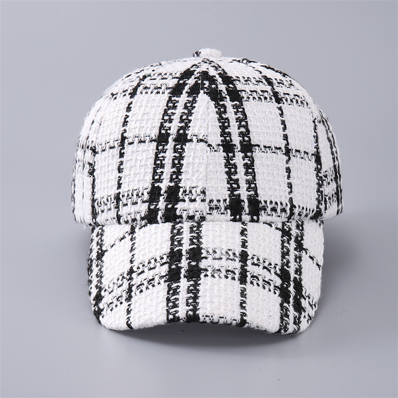 Front view of a white baseball cap with bold black plaid and a curved brim.