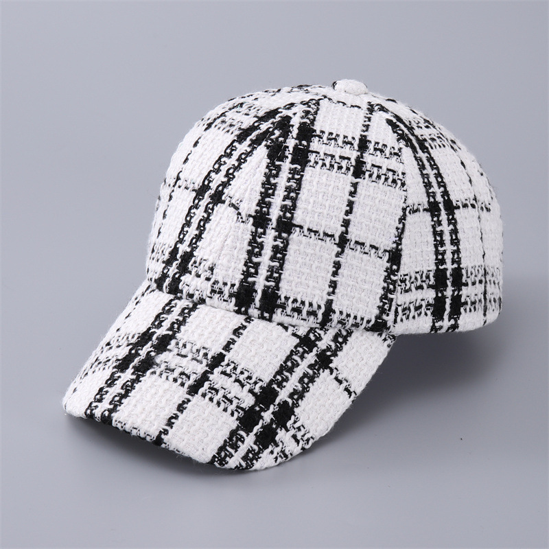 White baseball cap with bold black plaid and a curved brim, shown at an angle.