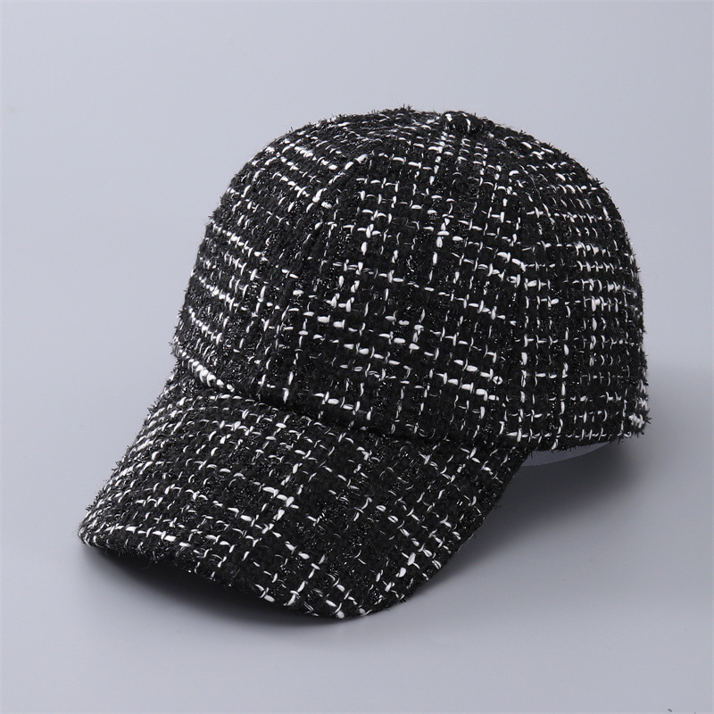 Black baseball cap with a fine white check pattern and curved brim, shown at an angle.