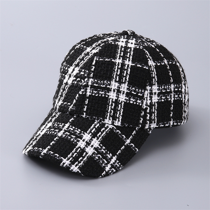 Black baseball cap with bold white plaid, shown from the front at an angle.