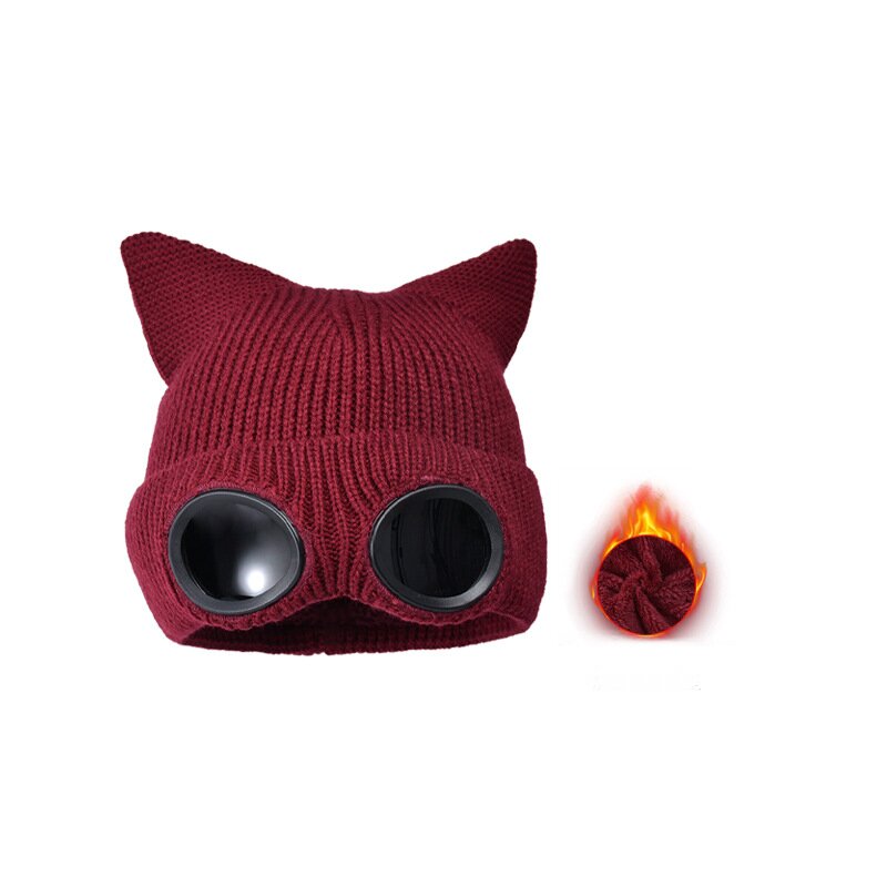 Burgundy cat ear knit hat with round dark lenses and a small lining detail inset.
