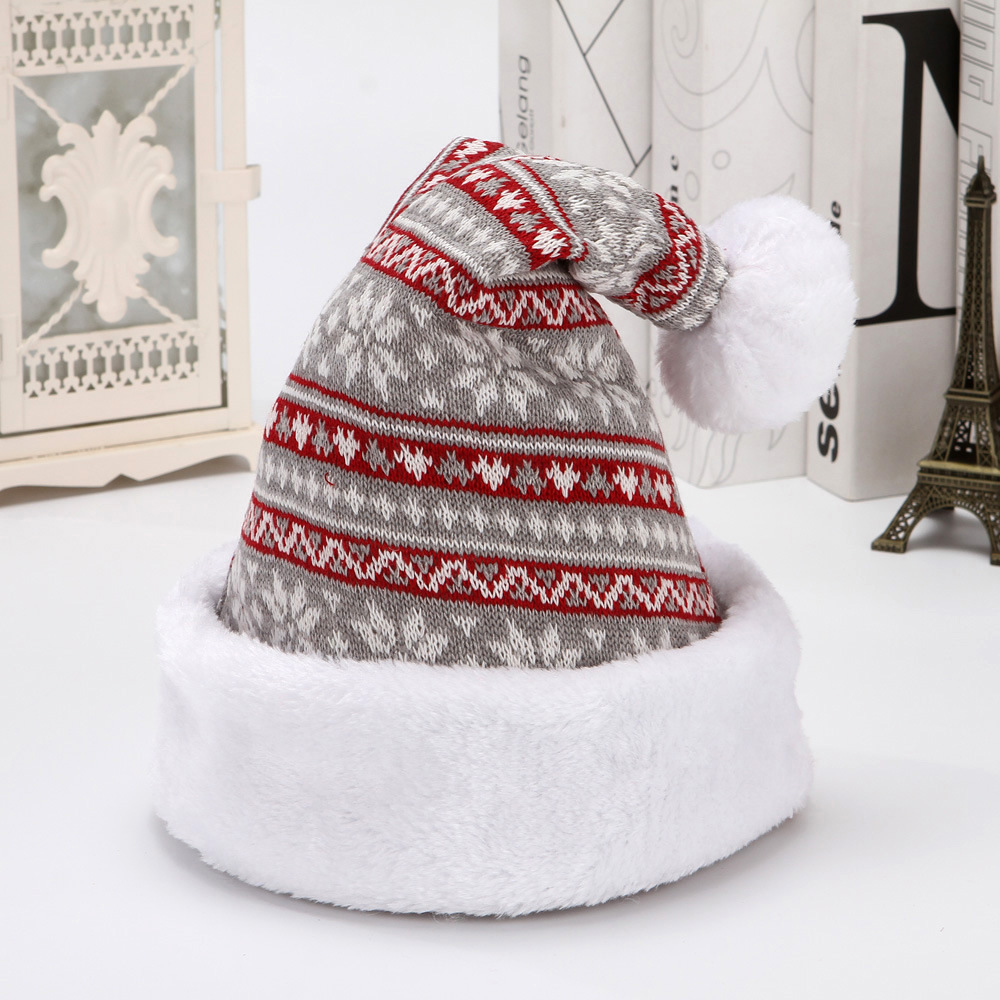 Grey knitted Christmas hat with red and white patterned stripes, a white plush cuff and pom-pom.