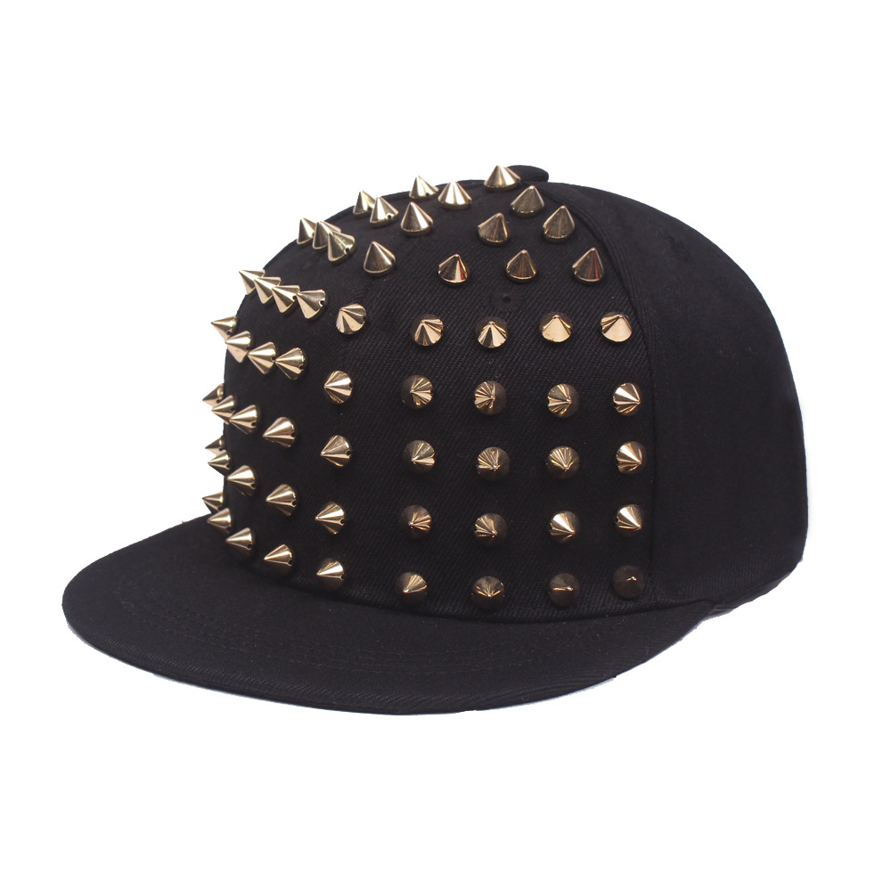 Black flat brim cap with gold-tone cone studs across the front panels.