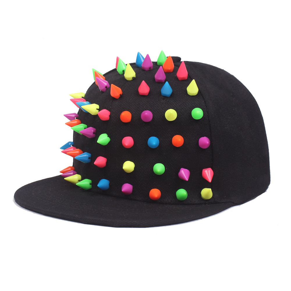 Black flat brim cap with multicolored cone studs on the front.