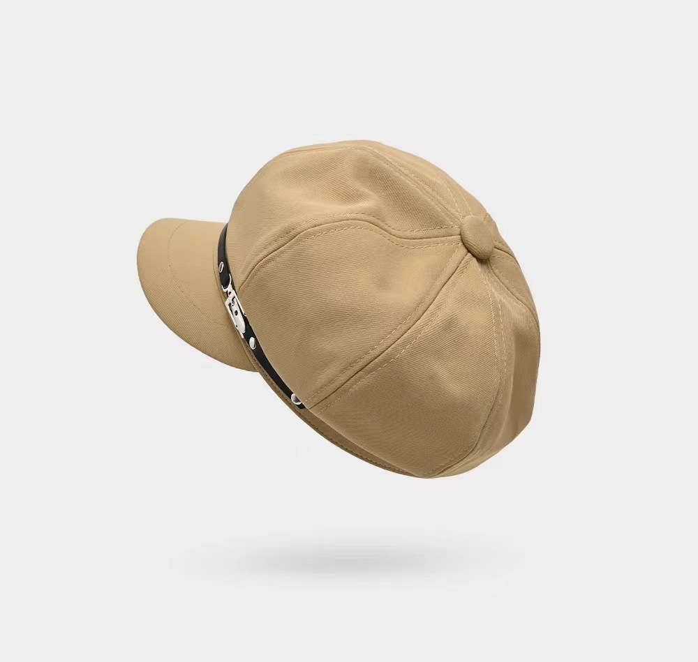 Top view of a khaki newsboy cap showing crown panels, seams and a covered button
