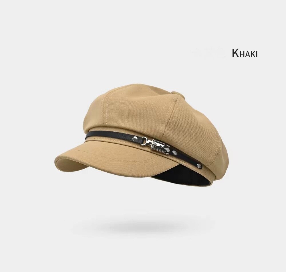 Khaki newsboy cap shown from the front at an angle with decorative trim above the brim