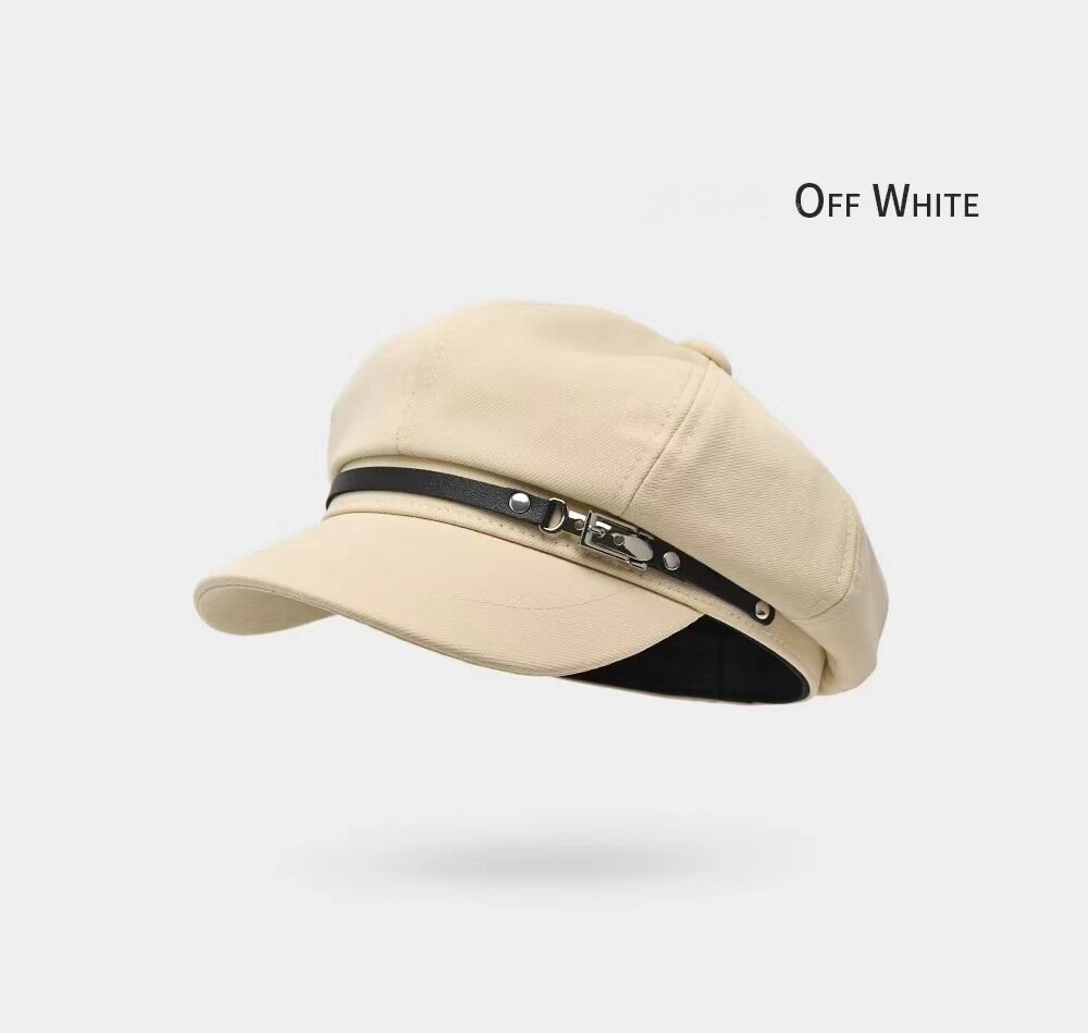Light beige newsboy cap with a black front band and silver-tone hardware
