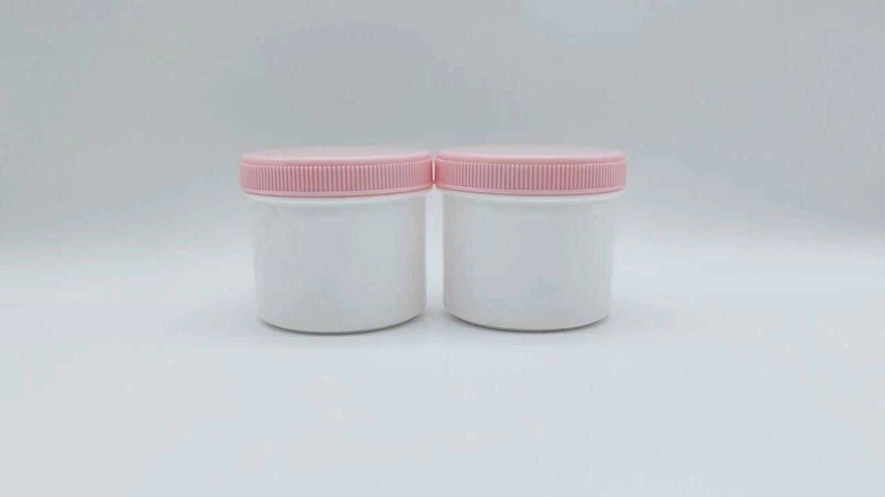 Glamorosos frascos cilíndricos de PP blanco de pared simple para crema de 250 g/300 g con tapas rosas 1