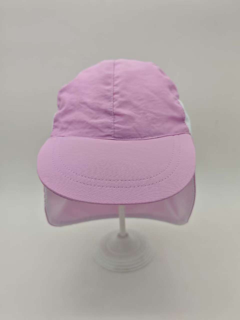 Purple kids cap with a curved brim and neck flap, shown from the front.