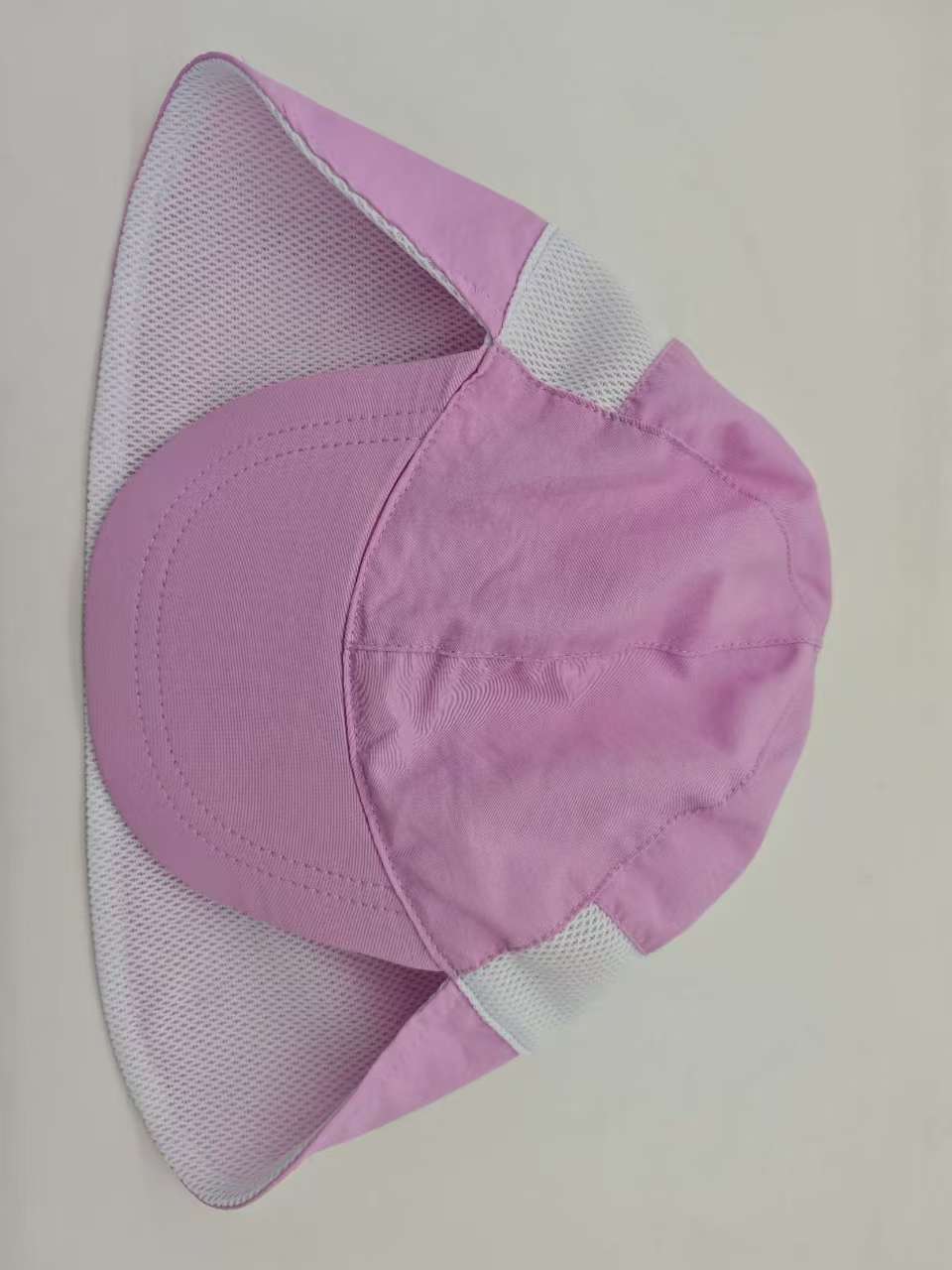 Purple kids cap laid flat with its brim, mesh side panels and neck flap visible.