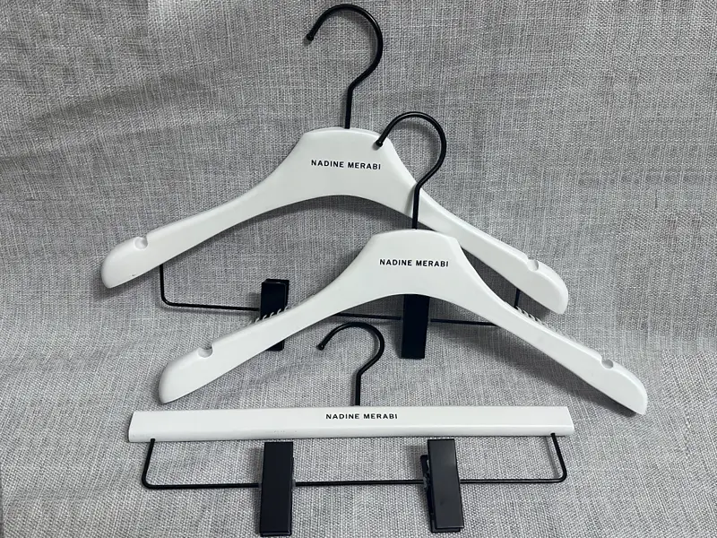 Matt white wooden hanger with black printed logo 1