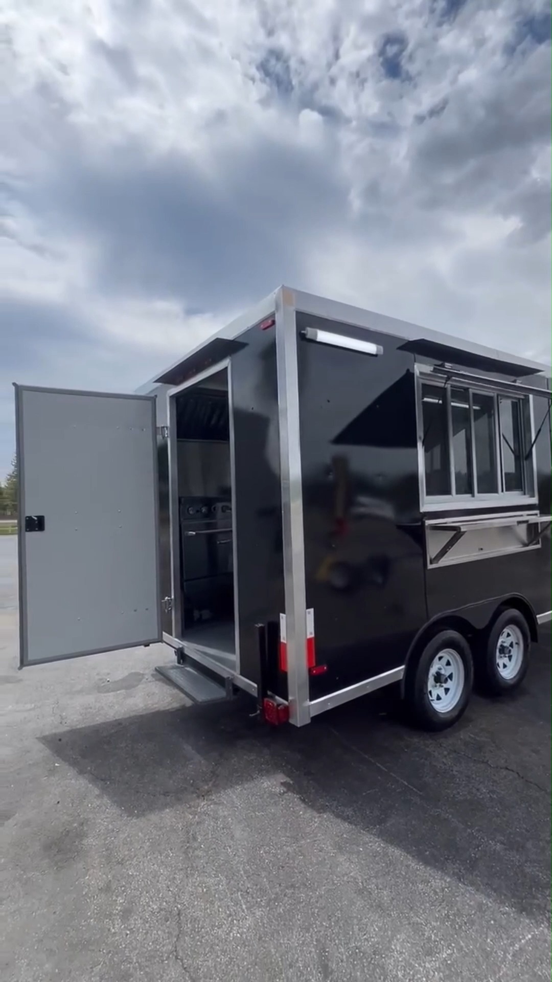 Sleek Black Dual - Axle Food Trailer with Stainless Steel Serving Window 1