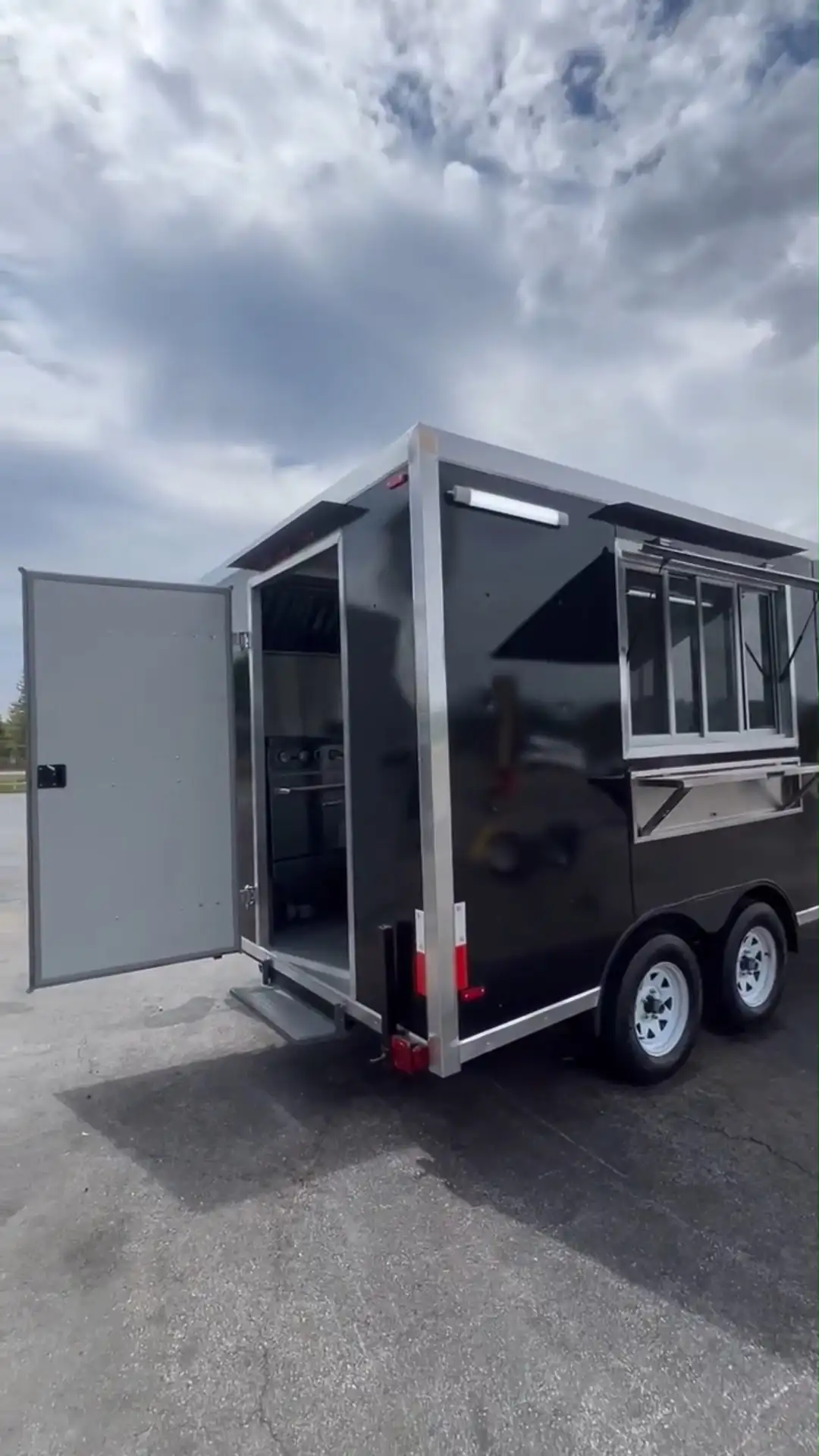 Sleek Black Dual - Axle Food Trailer with Stainless Steel Serving Window 1