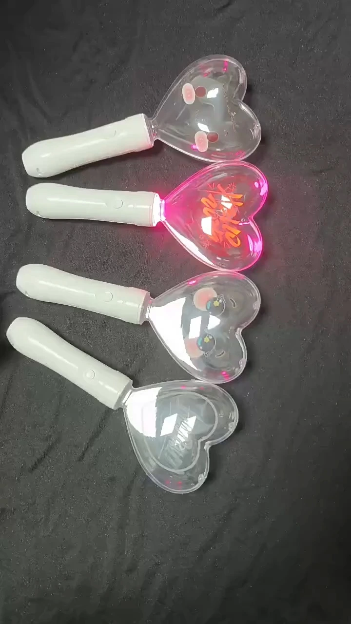 Handheld heart-shaped Kpop light stick demonstrating 15 selectable LED colors via manual button control.