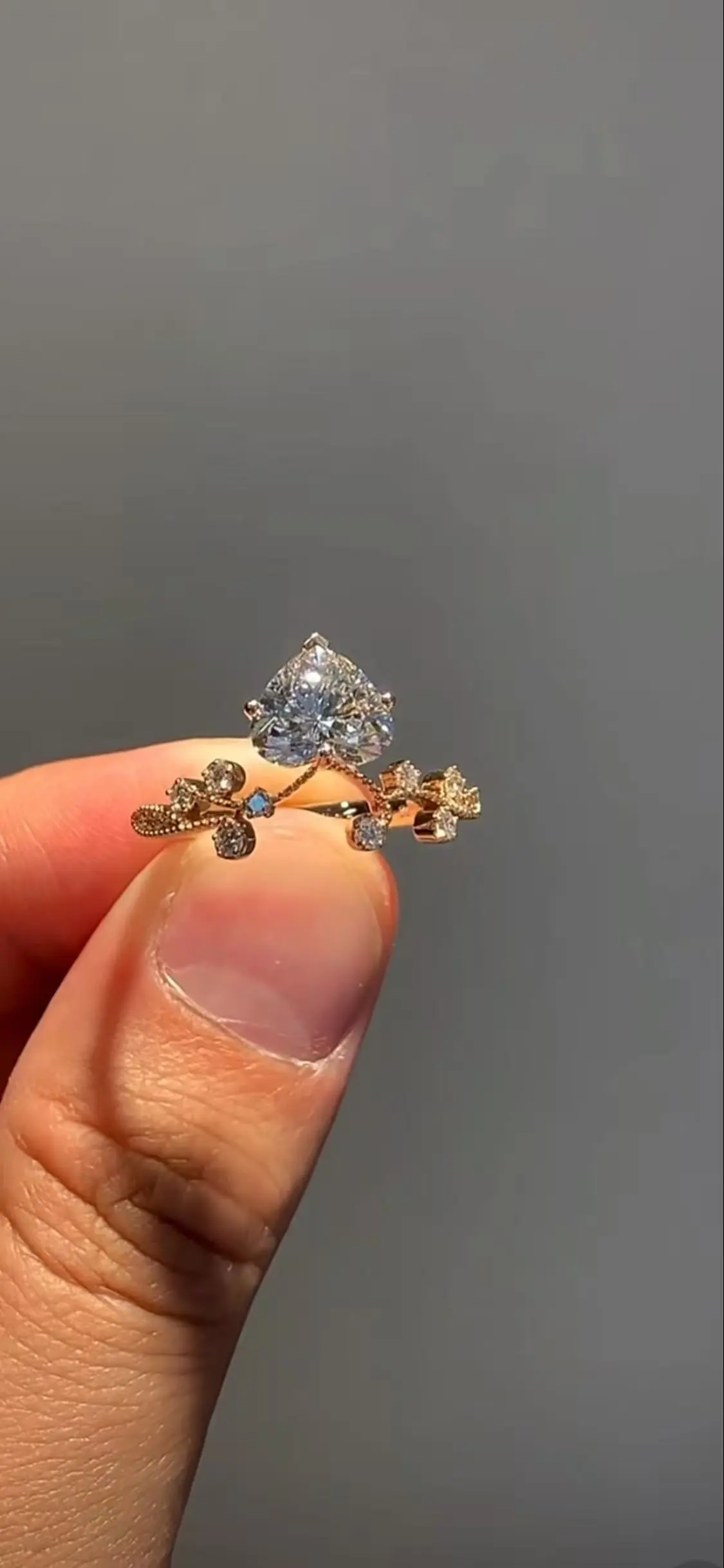 A light - luxury style diamond ring with a heart - shaped main diamond, set in 18K gold 1