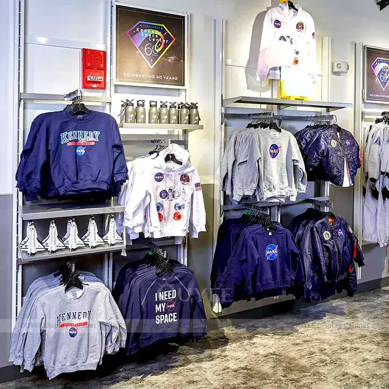 Space-Themed Apparel Store Fixtures With Circular Island Tables And Wall Displays 1