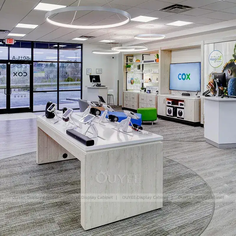 Telecom Experience Store Fixtures With Demo Tables And Round Seating Bench 1