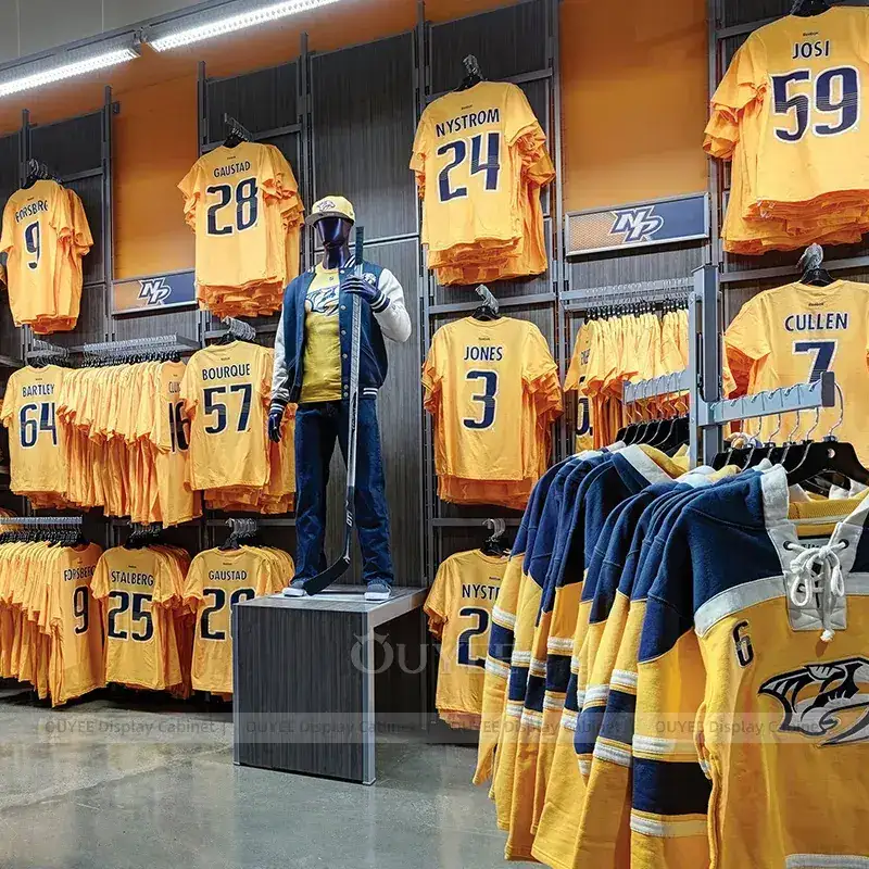 Stadium Team Store Fixtures With Orange Apparel Walls And Service Counter 1