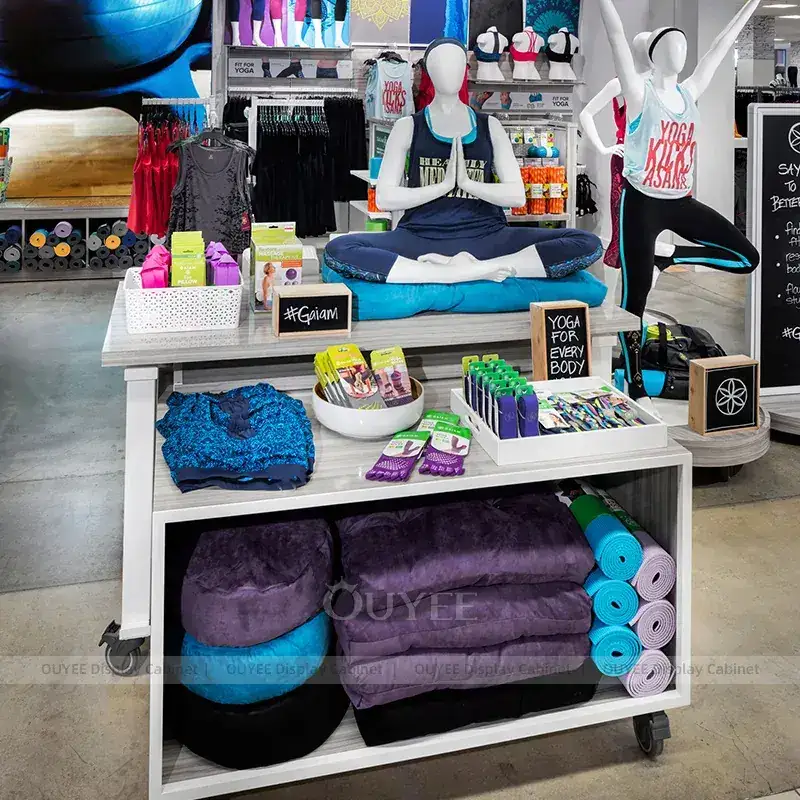 Activewear Boutique Fixtures With Mannequin Platforms And Wellness Accessory Tables 1