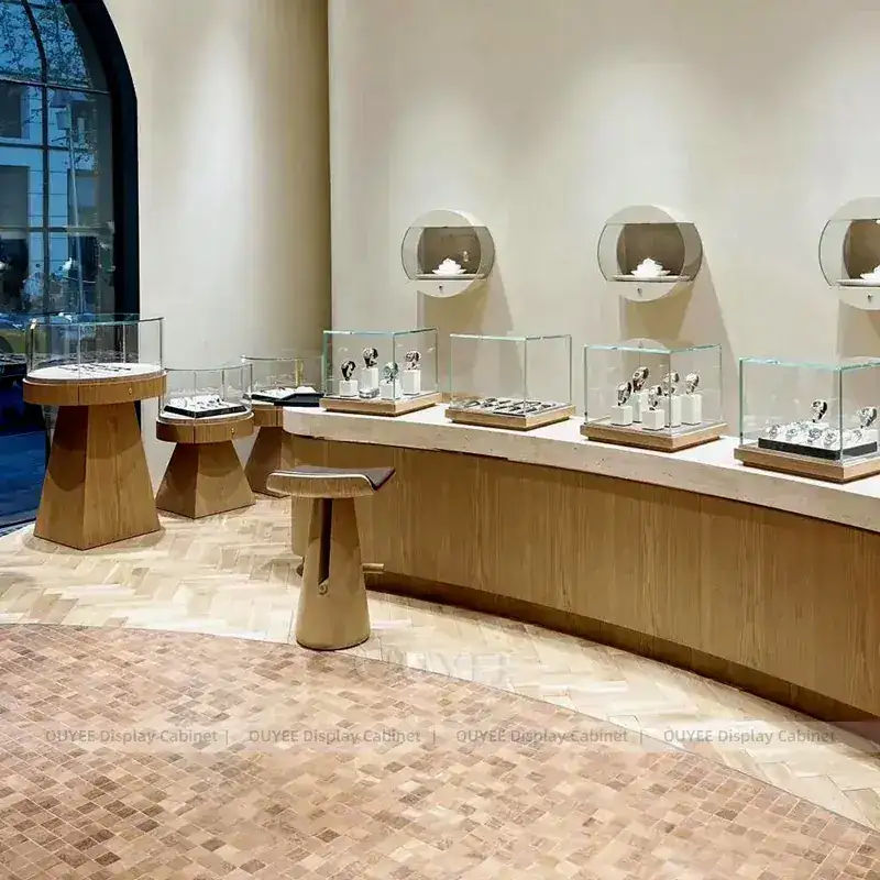 Sophisticated White Jewelry Store Display Table With Curved Glass Islands 1