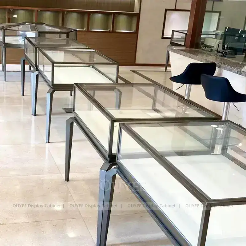 Sophisticated Marble Accent Jewelry Store Display Table With Curved Glass Islands 1