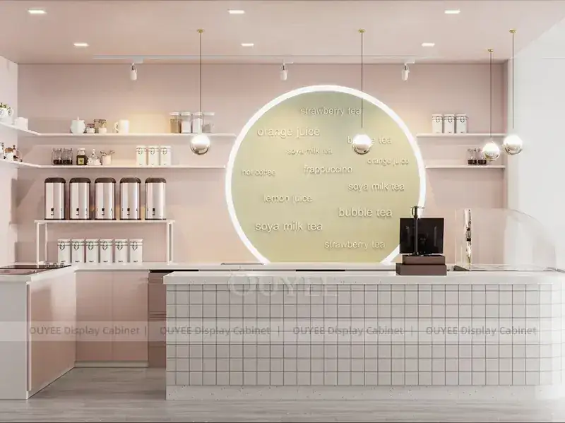 Boutique de bubble tea vert crème avec un mur orné d'un logo de chat et un comptoir incurvé 1