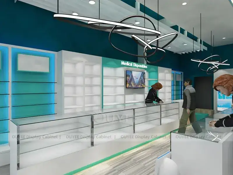 Interno di una farmacia color verde acqua con banconi di servizio bianchi. 1
