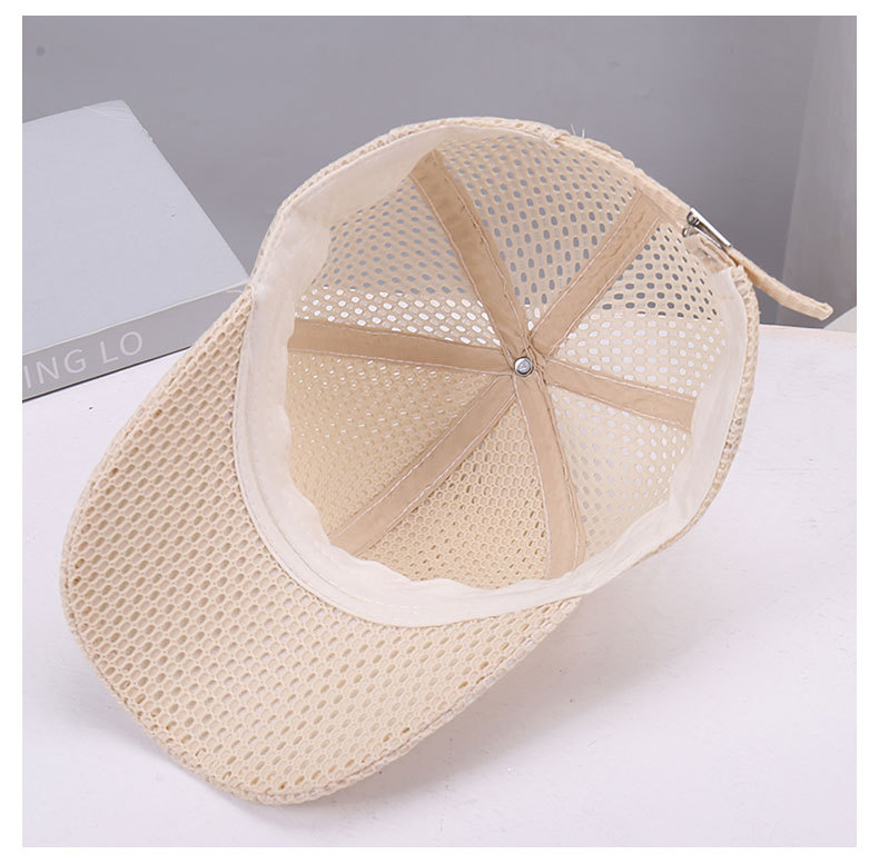 Inside view of a beige mesh cap showing seam tapes, the inner band and the underside of the brim