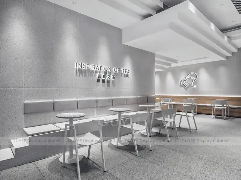 Aménagement intérieur d'un café orange et or avec vitrine à desserts incurvée 1