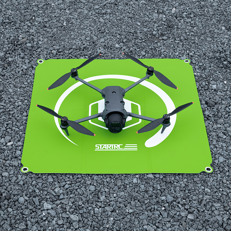 Square drone landing pad with four ground stakes