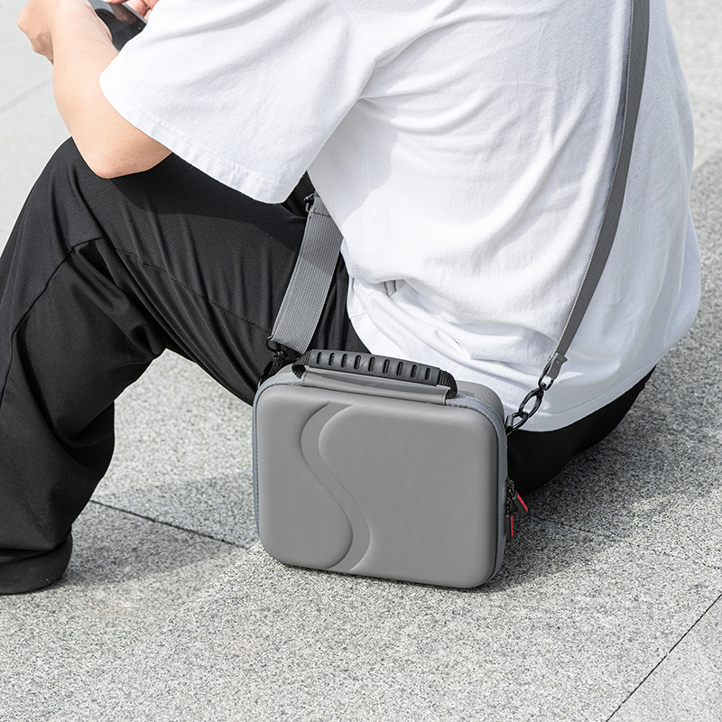 Top handle and detachable shoulder strap on the carrying case