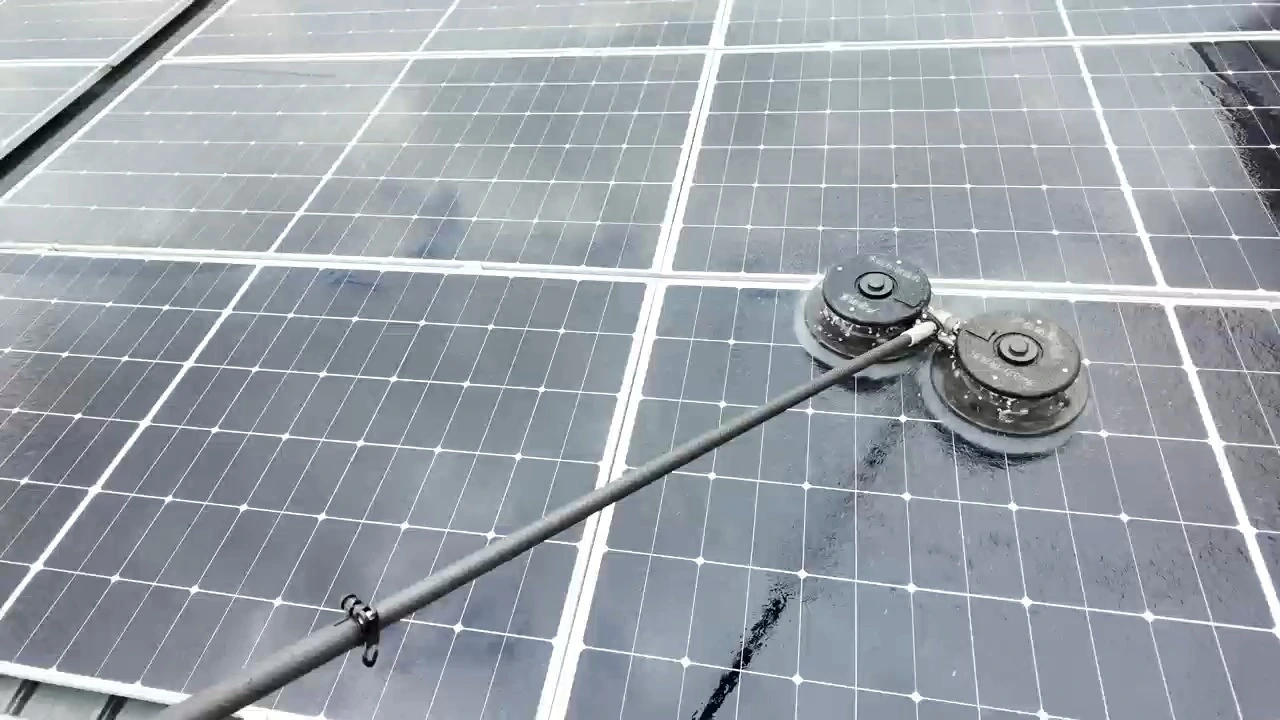 worker use NBK water power double head brush to cleaning the panels of California