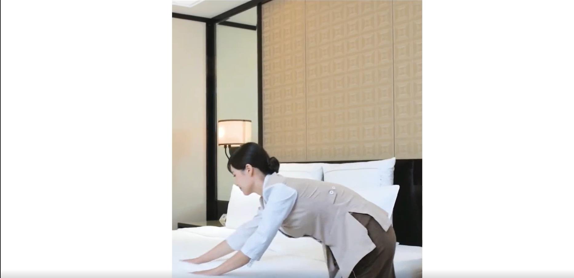 Hotel room staff professional make the bed without any wrinkles 2