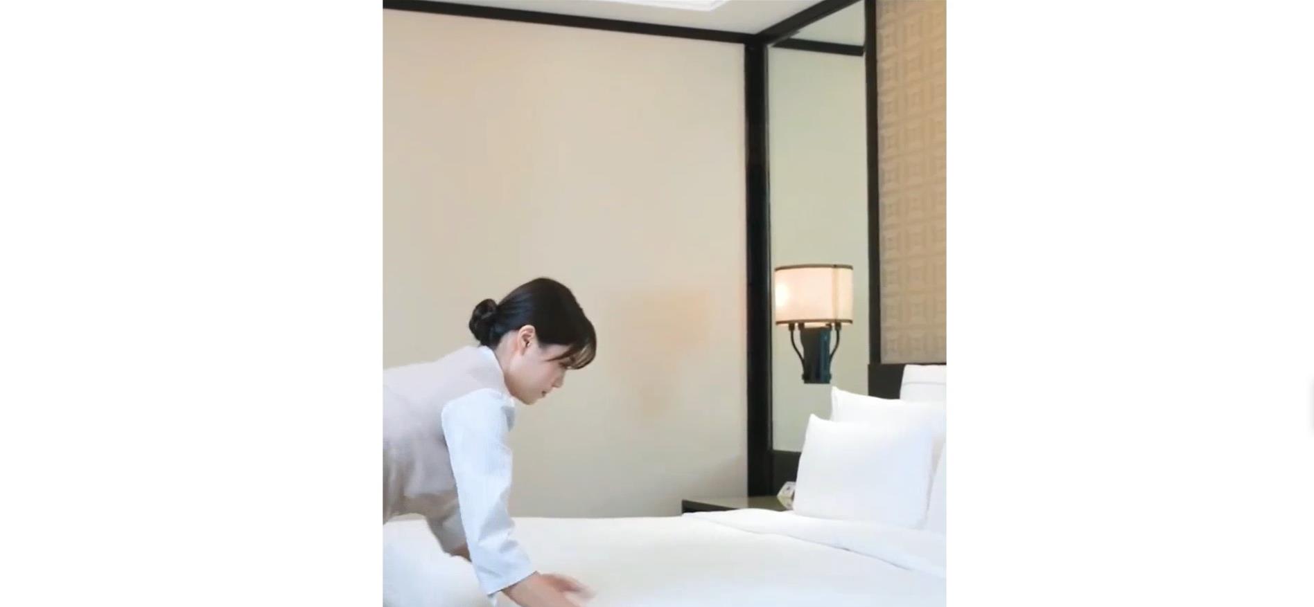 Hotel room staff professional make the bed without any wrinkles 4