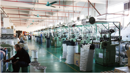 Workers operating weaving machines to produce durable webbing for dog harnesses and leashes