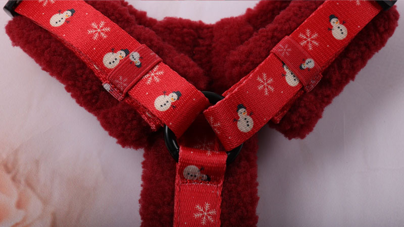 Metal O-ring connecting the shoulder straps and central webbing to improve harness stability and stress distribution