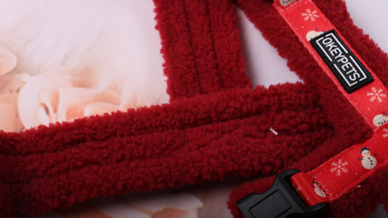 Close-up of plush red sherpa fleece fabric used on the inside of the dog harness for extra warmth and comfort