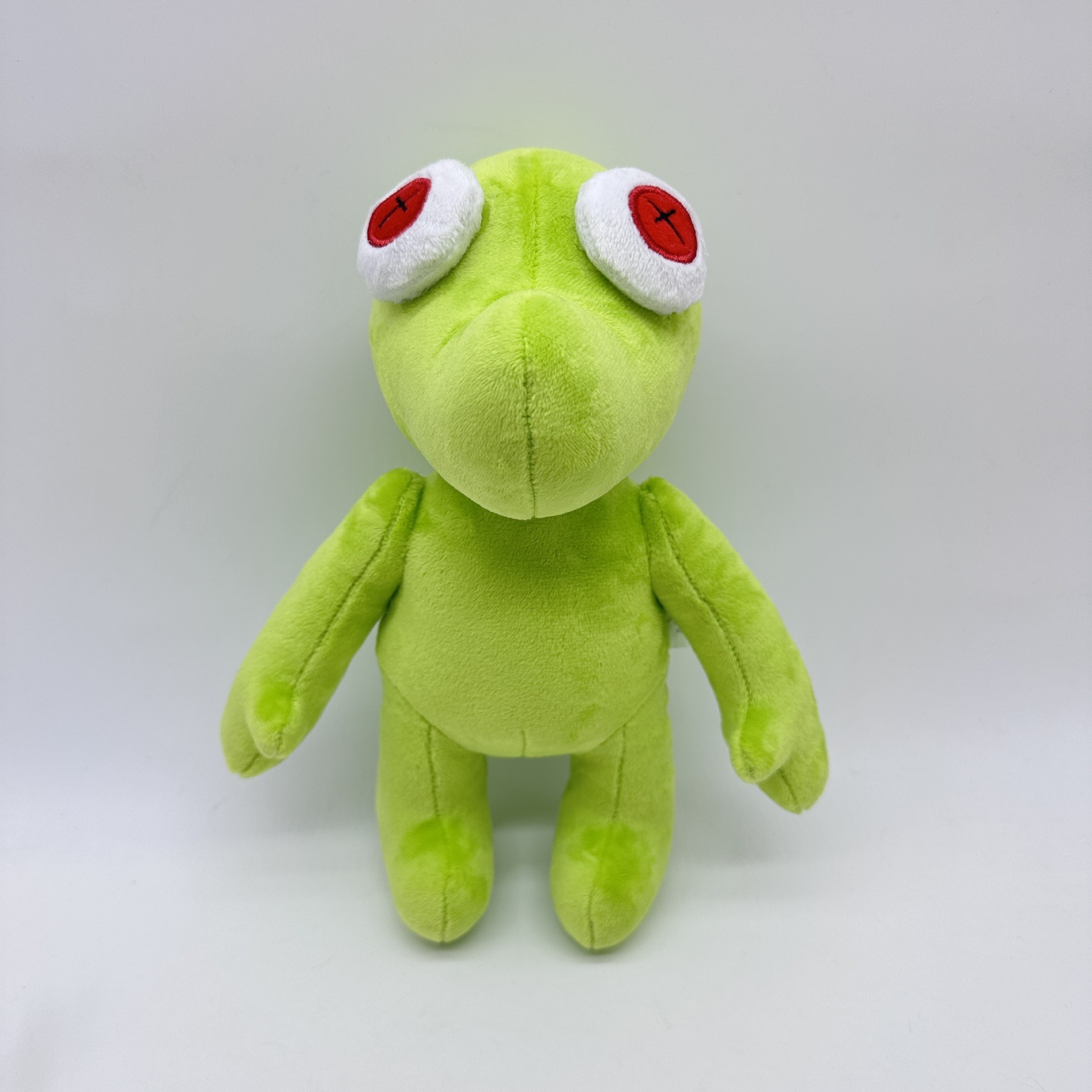 Peluche Petite Grenouille Verte Vibrante Runmo - Poupée en Peluche de 26 cm avec des yeux en croix rouge 26