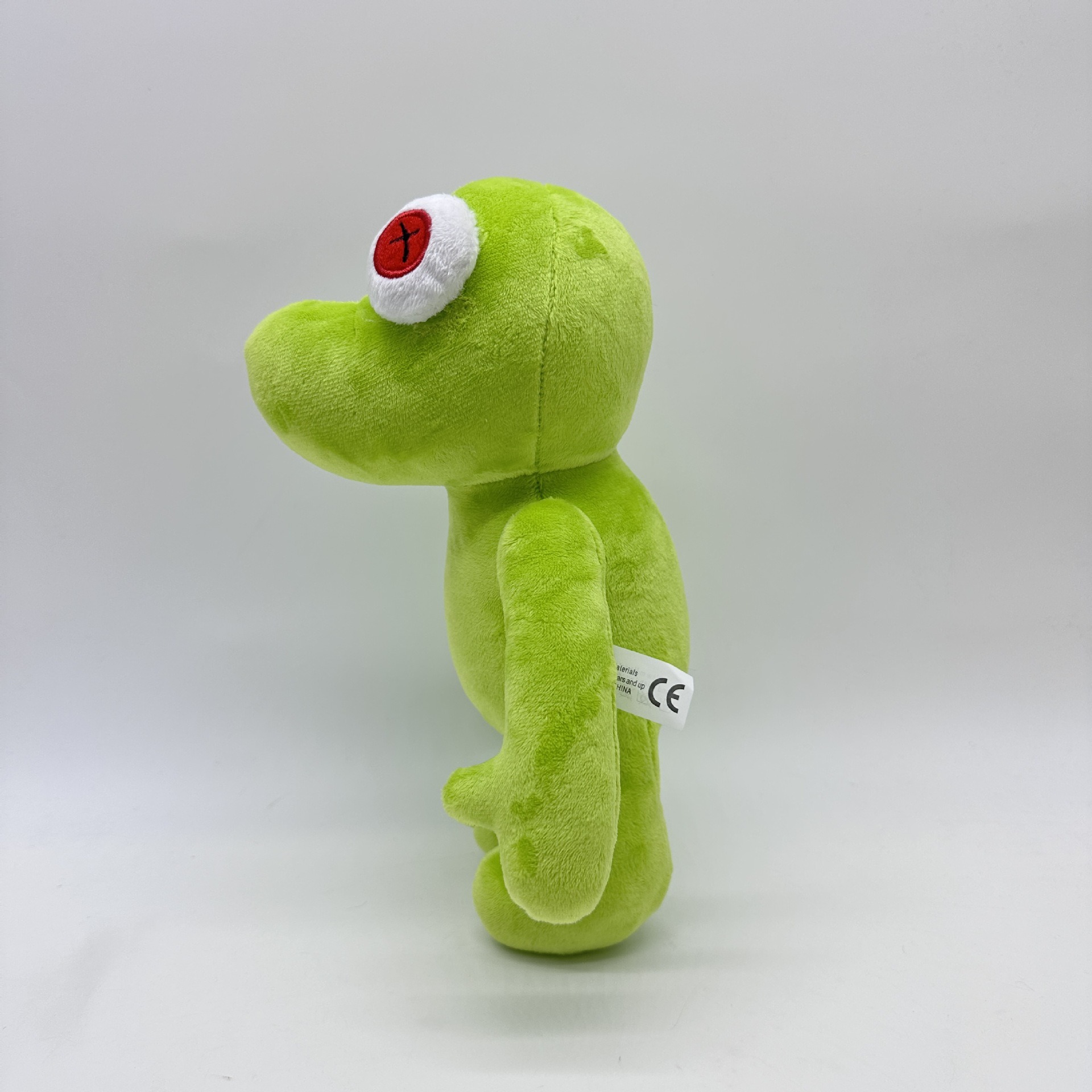 Peluche Petite Grenouille Verte Vibrante Runmo - Poupée en Peluche de 26 cm avec des yeux en croix rouge 24