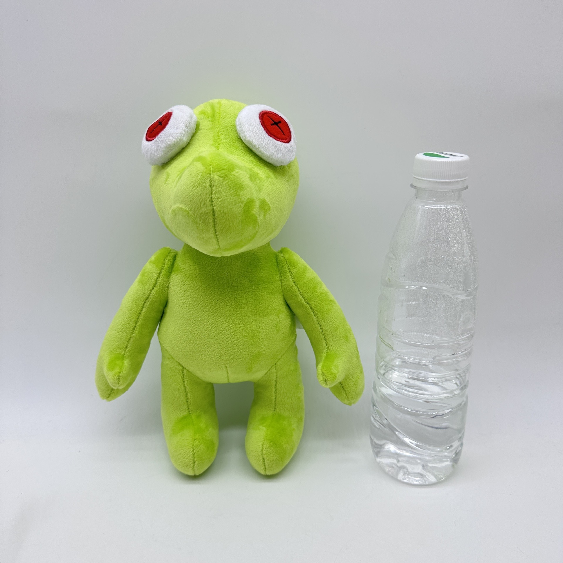 Peluche Petite Grenouille Verte Vibrante Runmo - Poupée en Peluche de 26 cm avec des yeux en croix rouge 25