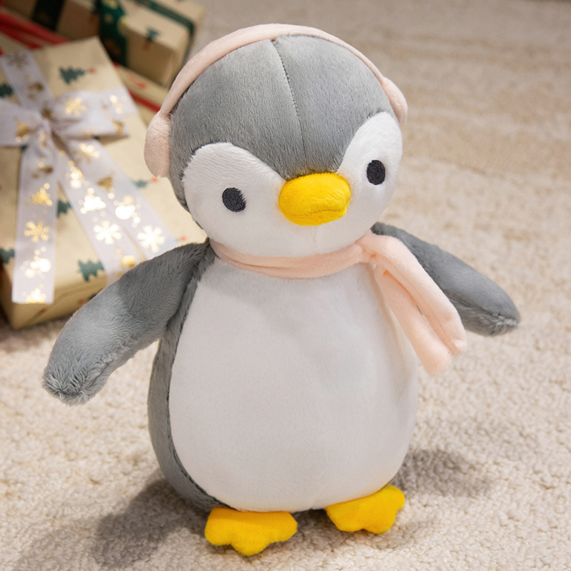 A plush doll in the unique shape of a penguin wearing headphones, a gift for children 13