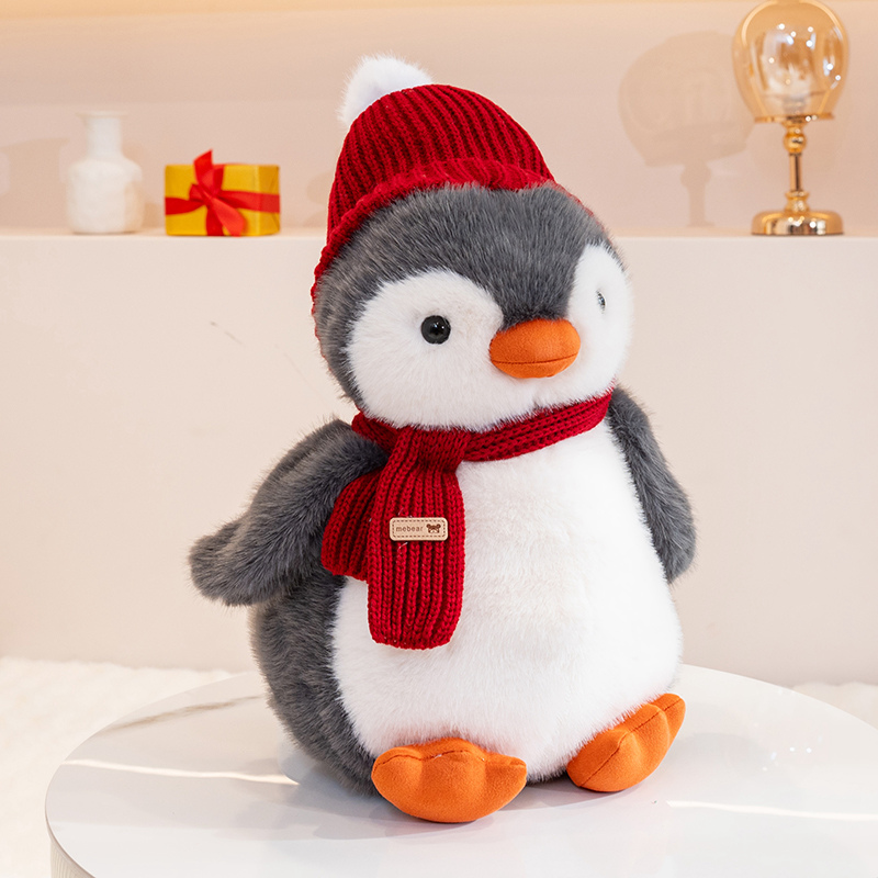 Penguin plush toy wearing a red hat and scarf, with a unique and creative design featuring cute animals to accompany 14