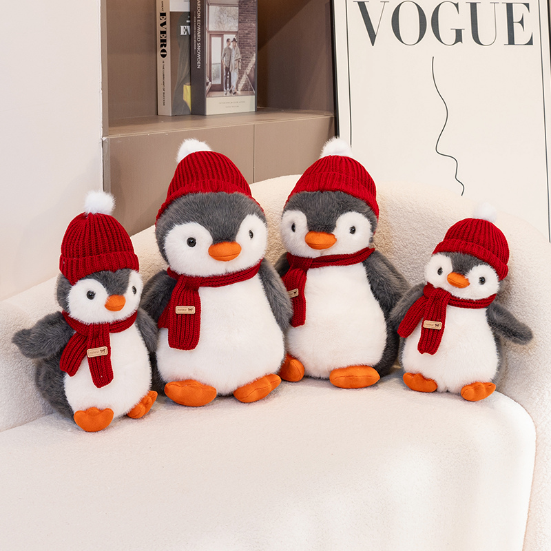 Penguin plush toy wearing a red hat and scarf, with a unique and creative design featuring cute animals to accompany 11