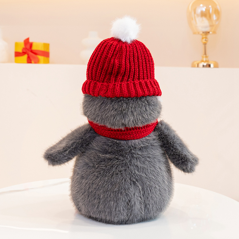 Penguin plush toy wearing a red hat and scarf, with a unique and creative design featuring cute animals to accompany 15