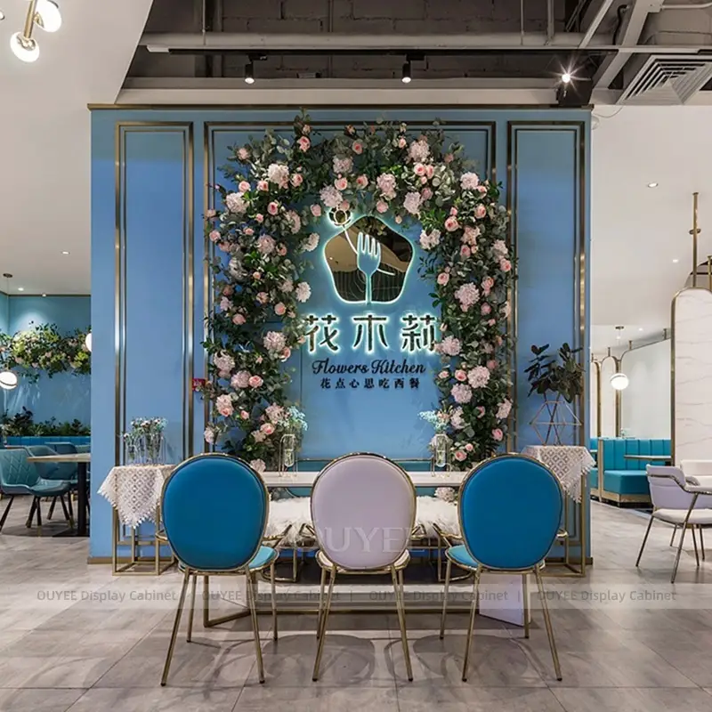 Modern Café Seating Area with Blue Booth Seating and Statement Lighting 1