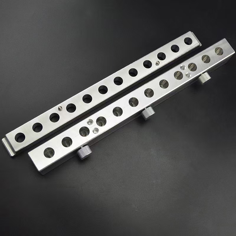 Close-up of 12 holes in aluminum lipstick filling mold