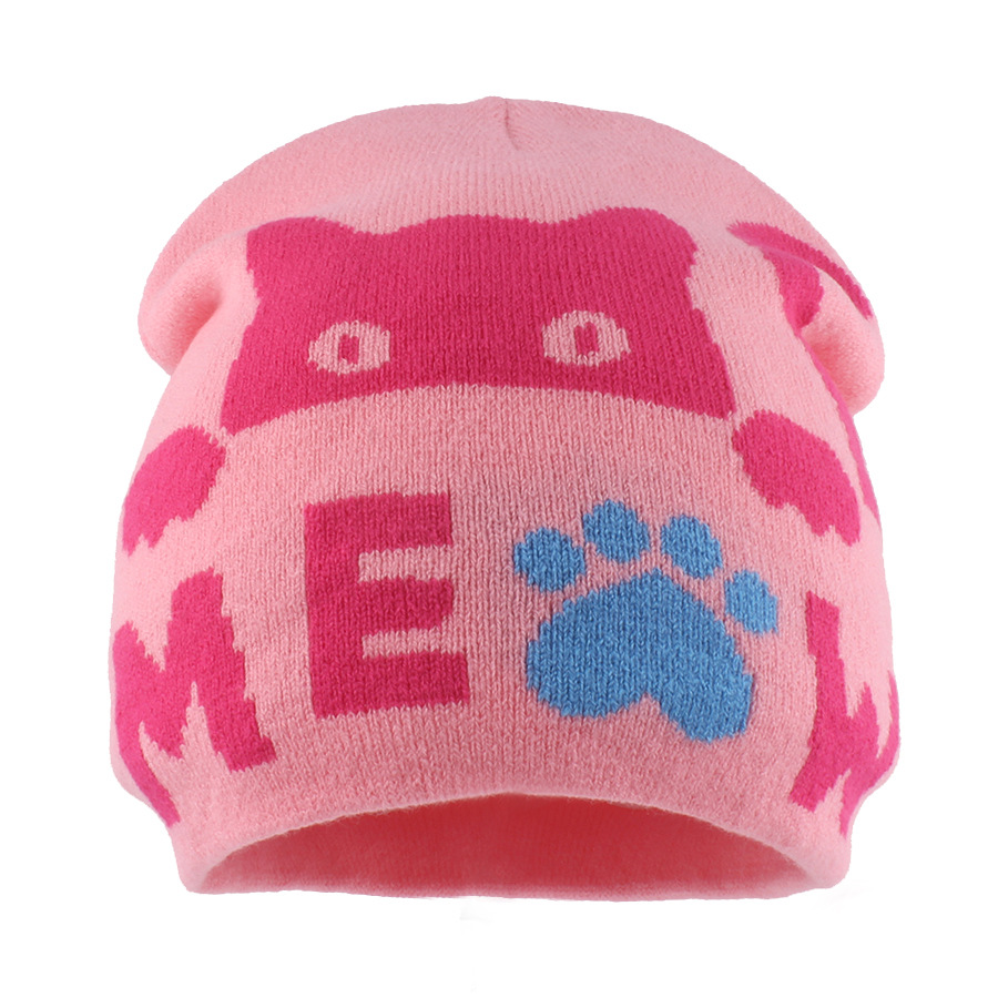 Pink knit beanie with a dark pink cat face and letters and a blue paw motif.