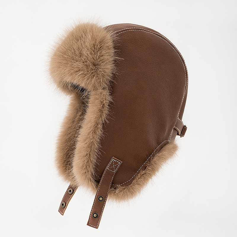Brown trapper hat with tan plush trim, lowered earflaps and snap-fastening chin straps.