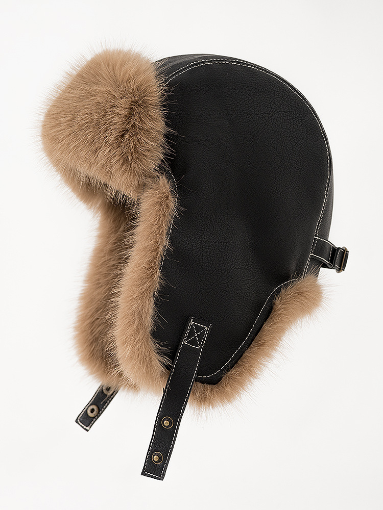 Black trapper hat with tan plush trim, contrast stitching and snap-fastening chin straps.